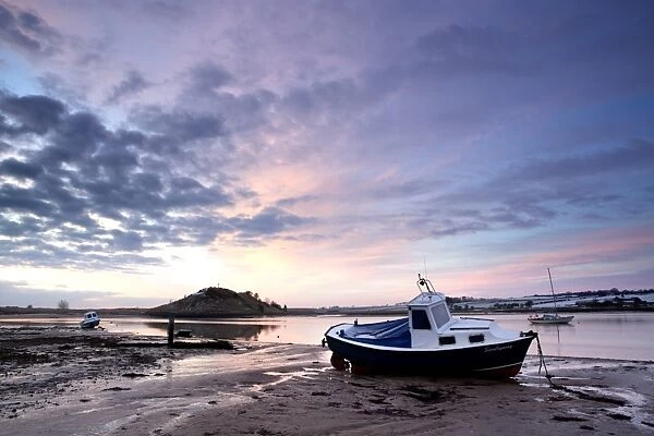 Winter sunrise on the Aln Estuary looking towards Church Hill with boats moored and reflections in the calm water, Alnmouth, near Alnwick, Northumberland, England, United Kingdom, Europe
