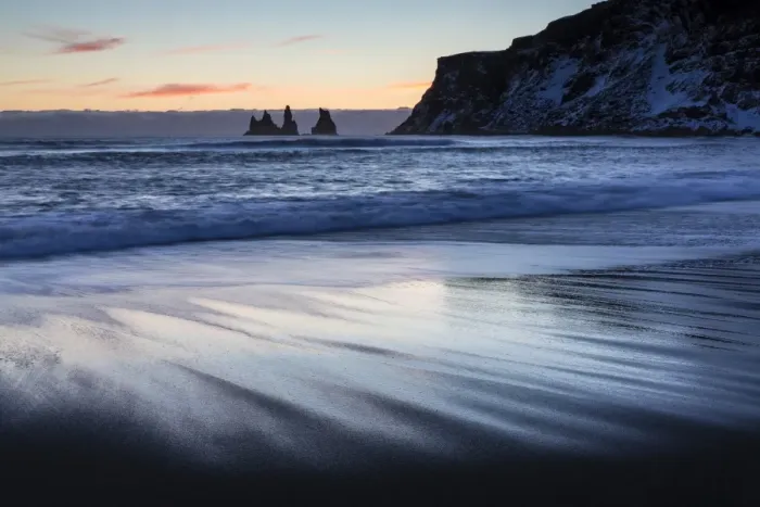 Framed Print : Winter sunset on black volcanic sand beach looking towards rock stacks of Reynisdrangar Framed Print : Winter sunset on black volcanic sand beach looking towards rock stacks of Reynisdrangar