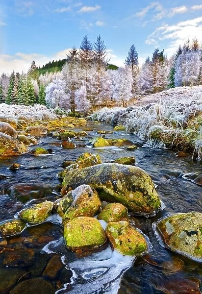 A winter view of the flowing water and colourful rocks of the River Polloch in the
