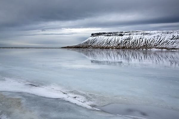Winter view over a frozen lake towards snow-covered headland near Grundarfjordur, Snaefellsnes Peninsula, Iceland, Polar Regions