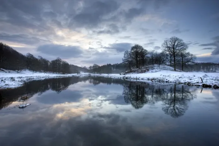 Framed Print : Winter view of River Brathay at dawn, under snow with reflections, near Elterwater Village