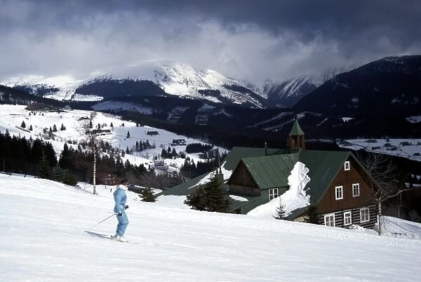 Winter view of skier on slopes at Pec Pod Snezkou with Snezka Mountain
