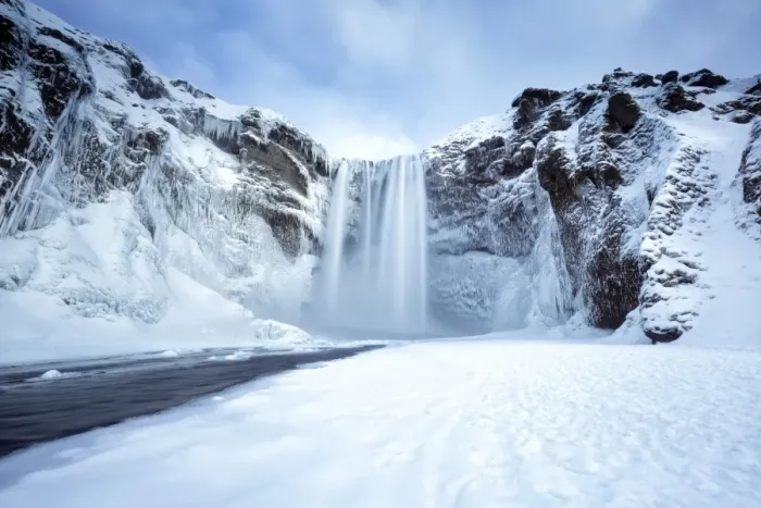 Framed Print : Winter view of Skogafoss waterfall, with cliffs covered in icicles and foregreound covered in snow Framed Print : Winter view of Skogafoss waterfall, with cliffs covered in icicles and foregreound covered in snow