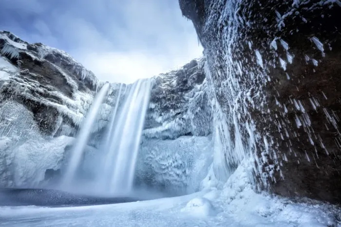 Framed Print : Winter view of Skogafoss waterfall, with cliffs covered in icicles and foregreound covered in snow Framed Print : Winter view of Skogafoss waterfall, with cliffs covered in icicles and foregreound covered in snow