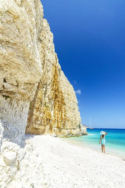 Woman admiring the white limestone cliffs standing on Fteri Beach, Kefalonia, Ionian Islands, Greek Islands, Greece, Europe