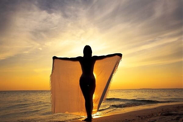 Woman on a beach at sunset, Maldives, Indian Ocean, Asia