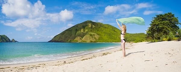 Woman celebrating freedom at Mawun Beach, a Tropical Paradise in South Lombok, Indonesia, Southeast Asia, Asia