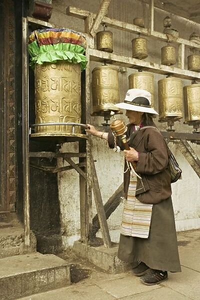 Woman circuits the inner Jokhang temple, walking the circumambulation pathway (Nangkhor)