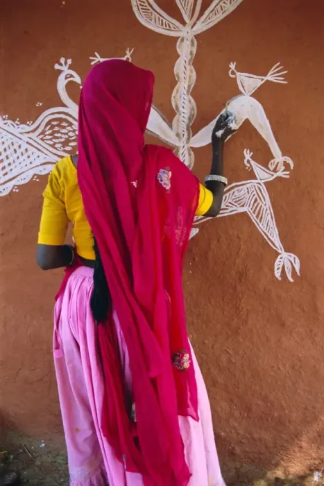 Framed Print : Woman decorating her house with traditional local designs Framed Print : Woman decorating her house with traditional local designs