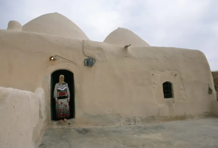 Framed Print : Woman in doorway of a 200 year old beehive house in the desert Framed Print : Woman in doorway of a 200 year old beehive house in the desert