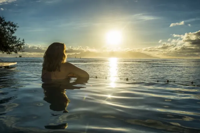 Framed Print : Woman enjoying the sunset in a swimming pool with Moorea in the background, Papeete Framed Print : Woman enjoying the sunset in a swimming pool with Moorea in the background, Papeete