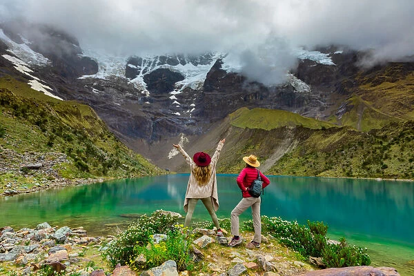 Two woman enjoying the view of crystal clear Humantay Lake, Cusco, Peru, South America