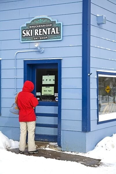 Woman entering ski rental store
