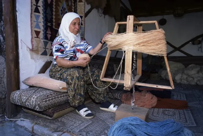 Framed Print : Woman gathering dyed wool in carpet workshop Framed Print : Woman gathering dyed wool in carpet workshop