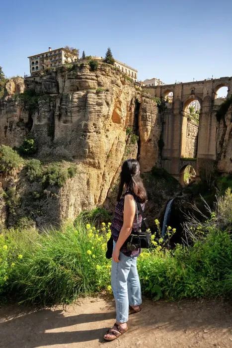 Framed Print : Woman looking at historic bridge of Ronda, Pueblos Blancos, Andalusia, Spain, Europe Framed Print : Woman looking at historic bridge of Ronda, Pueblos Blancos, Andalusia, Spain, Europe