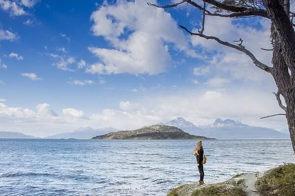 Woman looking out over the Magellan Straits and Darwin Mountain range in Tierra del