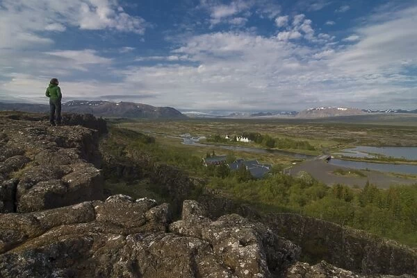 Woman looking at the vast bare landscape of Pingvellir, where the American