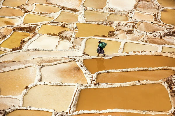 Woman mining salt, Salineras de Maras, Maras Salt Flats, Sacred Valley, Peru, South