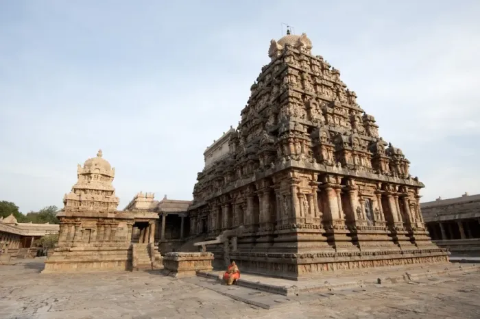 Framed Print : Woman in orange sari sitting beside the vimala section of Swaminathaswamy temple Framed Print : Woman in orange sari sitting beside the vimala section of Swaminathaswamy temple