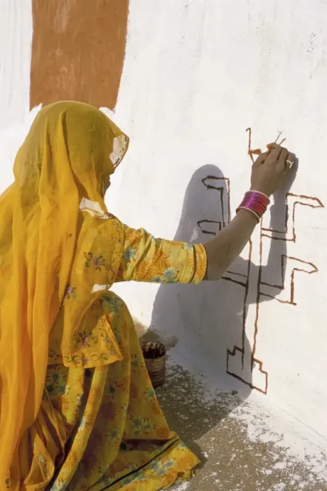 Framed Print : Woman painting design on a wall in a village near Jaisalmer Framed Print : Woman painting design on a wall in a village near Jaisalmer