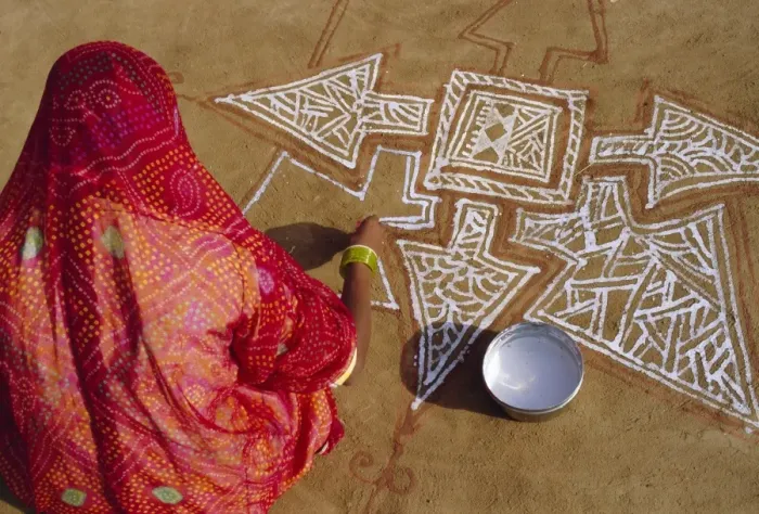 Framed Print : Woman painting a Mandala design on the ground Framed Print : Woman painting a Mandala design on the ground