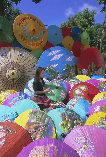 Woman painting umbrellas