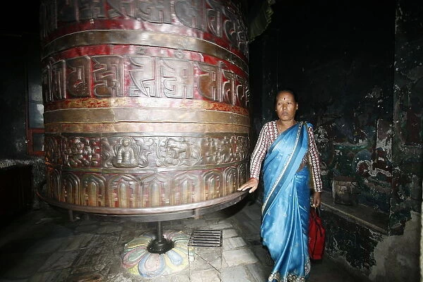Woman and prayer wheel, Swayambhunath Temple, Kathmandu, Nepal, Asia