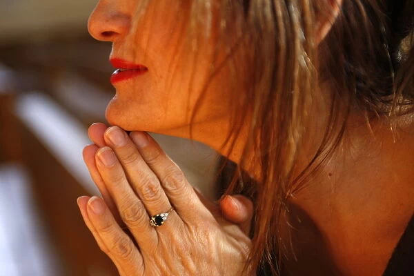 Woman praying in church, Haute Savoie, France, Europe