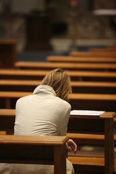Woman praying in church, Rome, Lazio, Italy, Europe