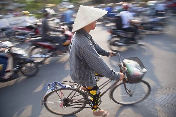 Woman riding bicycle, Hue, Thua Thien-Hue, Vietnam, Indochina, Southeast Asia, Asia