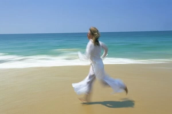 Woman running along beach