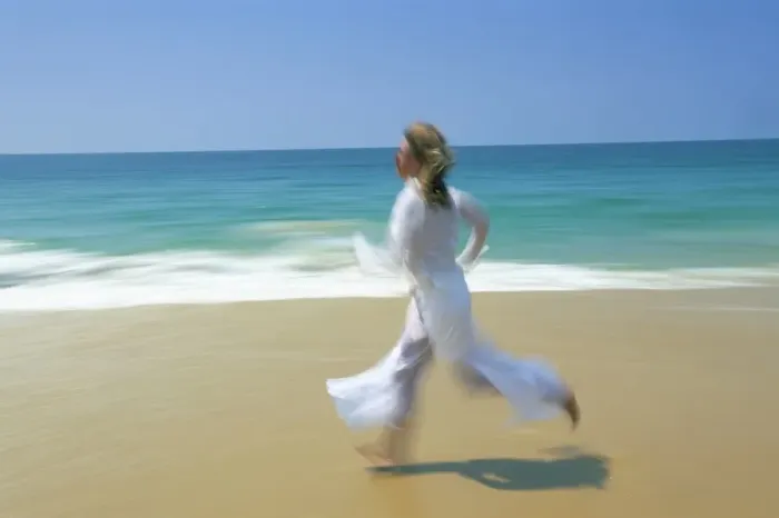 Framed Print : Woman running along beach Framed Print : Woman running along beach