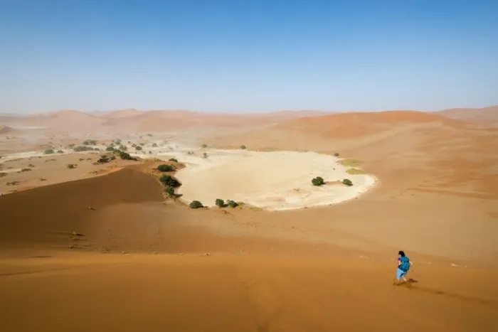 Framed Print : A woman runs down from the summit of Sossusvlei sand dune, Namibia, Africa Framed Print : A woman runs down from the summit of Sossusvlei sand dune, Namibia, Africa