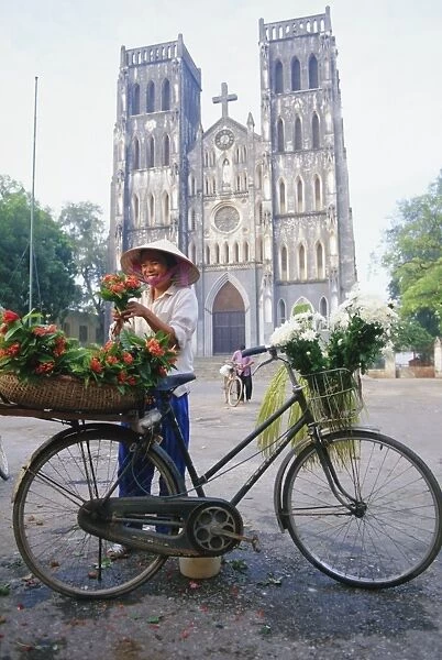 Woman selling flowers off her bicycle