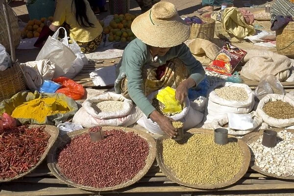 Woman selling peanuts and other pulses at local market, Kalaw, Shan State