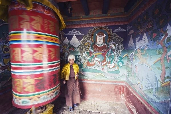 A woman spinning a prayer wheel, Chimi Lhakhang dating from 1499, Temple of the Divine Madman Lama Drukpa Kunley, Punakha