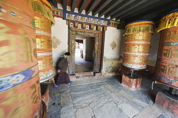 Woman spinning a prayer wheel, Jambay Lhakhang, built 659 by Tibetan King Songtsen Gampo