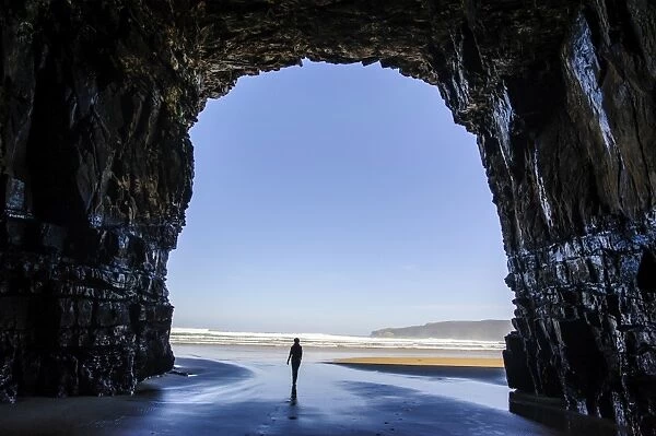 Woman standing in the giant Cathedral caves, The Catlins, South Island, New Zealand, Pacific
