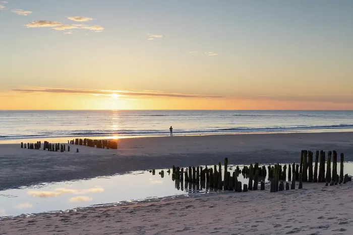 Framed Print : Woman standing next to wooden groynes on Rantum beach at sunset, Sylt, Schleswig Holstein, Germany, Europe Framed Print : Woman standing next to wooden groynes on Rantum beach at sunset, Sylt, Schleswig Holstein, Germany, Europe
