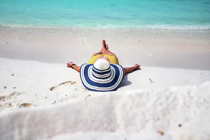 Framed Print : Woman with straw hat sunbathing on tropical beach, The Maldives, Indian Ocean