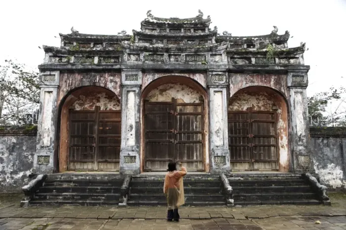 Framed Print : Woman taking photo of temple gates, Vietnam, Indochina, Southeast Asia, Asia