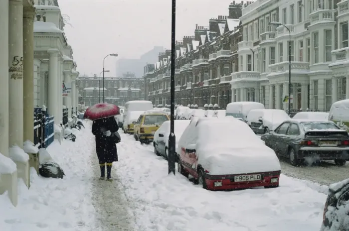 Framed Print : Woman with umbrella and cars covered in snow in winter in West Kensington Framed Print : Woman with umbrella and cars covered in snow in winter in West Kensington