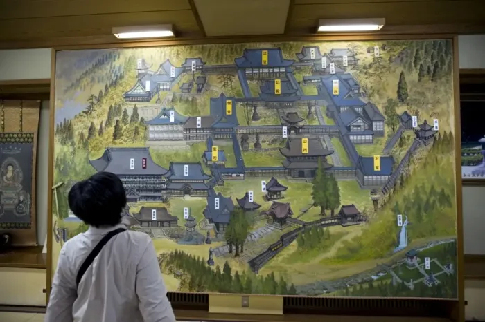 Framed Print : Woman viewing map of Eiheiji Temple, headquarters of Soto sect of Zen Buddhism