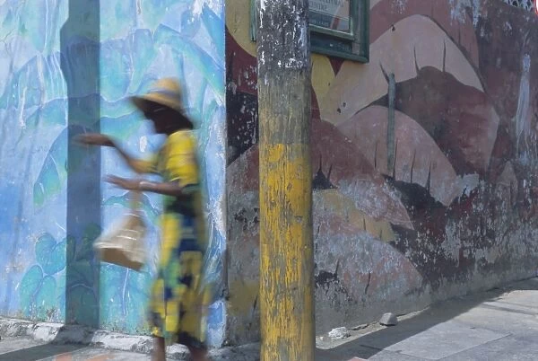 Woman walking in Anse La Raye, St