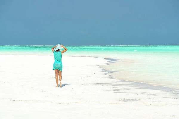 Woman walking on idyllic empty beach, Zanzibar, Tanzania, East Africa, Africa