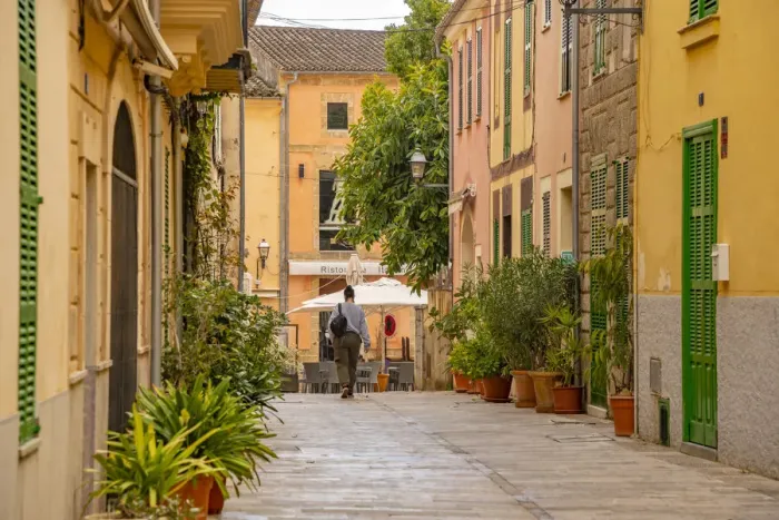 Framed Print : Woman walking down narrow street in the old town of Alcudia, Alcudia, Majorca, Balearic Islands, Spain, Mediterranean, Europe Framed Print : Woman walking down narrow street in the old town of Alcudia, Alcudia, Majorca, Balearic Islands, Spain, Mediterranean, Europe
