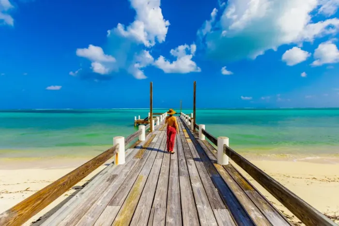 Framed Print : Woman walking up the pier that stretches out into the ocean from Horse Stable Beach Framed Print : Woman walking up the pier that stretches out into the ocean from Horse Stable Beach