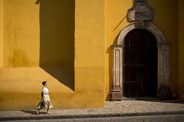 Woman walking along street, San Miguel de Allende, Guanajuato, Mexico, North America
