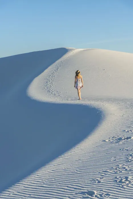 Framed Print : A woman walking along thes curve of a dunes ridge in White Sands National Park Framed Print : A woman walking along thes curve of a dunes ridge in White Sands National Park