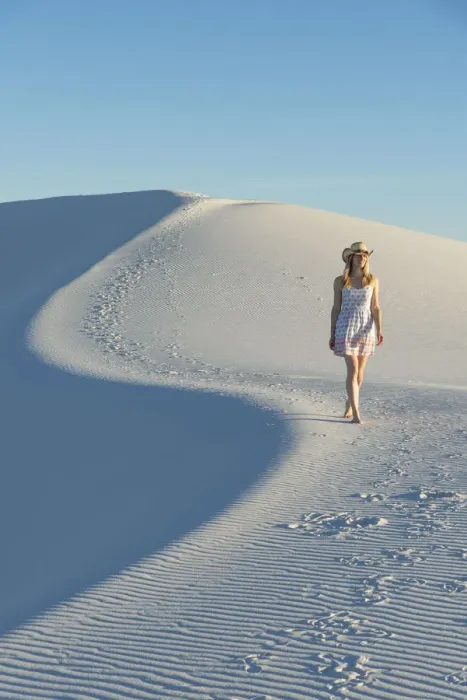 Framed Print : A woman walking along thes curve of a dunes ridge in White Sands National Park Framed Print : A woman walking along thes curve of a dunes ridge in White Sands National Park